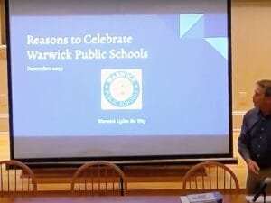 [CREDIT: City of Warwick] Mayor Frank Picozzi helps ready Warwick Schools Superintendent Lynn Dambruch's presentation on the State of Warwick Schools.