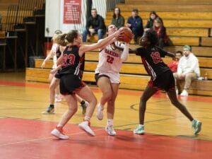 [CREDIT: Coventry Oaker Athletics/Facebook] Coventry's Emma Martin (22) drives to the hoop against Exeter-West Greenwich in this week's Coventry Sports roundup.