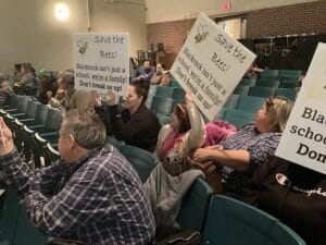 [CREDIT: Rob Borkowski] Parents, students and teachers crowded Allan Shawn Feinstein Middle School's auditorium Jan. 11 to oppose a Coventry schools restructure plan that would dissolve Black Rock Elementary School and convert it to an early learning center, reorganizing the remaining elementary schools. Pictured, from left, Ray Roboin, fourth grade teacher, Avery Rossi, 7, and Melissaa Nelson, PTO member.