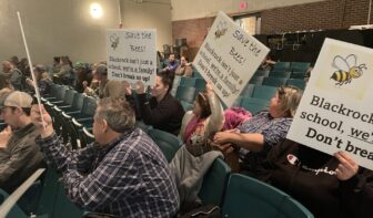 [CREDIT: Rob Borkowski] Parents, students and teachers crowded Allan Shawn Feinstein Middle School's auditorium Jan. 11 to oppose a Coventry schools restructure plan that would dissolve Black Rock Elementary School and convert it to an early learning center, reorganizing the remaining elementary schools. Pictured, from left, Ray Roboin, fourth grade teacher, Avery Rossi, 7, and Melissaa Nelson, PTO member.