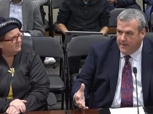 [CREDIT: Legislative Press & Information Bureau] At left, Rep. Camille F.J. Vella-Wilkinson's new bill would require state websites to be accessible to people with disabilities. Secretary of State Greg Amore, right speaks in support.