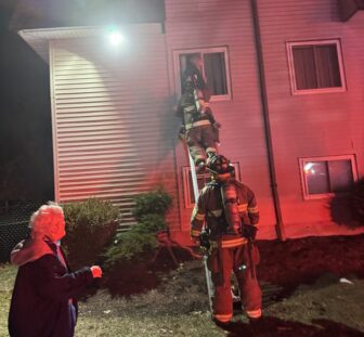 [CREDIT: Hopkins Hill Chief Frank Brown] Hopkins Hill Firefighters rescue two people trapped in their apartment by the March 11 fire at 978 Tiogue Ave. The man an woman were treated for smoke inhalation. A third resident was also treated for smoke inhalation. The ladder rescue was the first Chief Frank Brown has seen in 42 years in Coventry, he said.