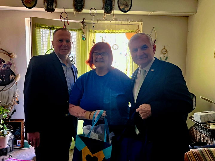 [CREDIT: Sen. Jack Reed's Office] Friday, U.S. Sen. Jack Reed (D-RI) helped Meals on Wheels of Rhode Island team members deliver a meal to Ms. Vivian Raposa, 76, in West Warwick, and her dog, Lulu. Pictured above, from left, Mike Florczyk, CEO, UnitedHealthcare Community Plan of Rhode Island, Vivian, and Reed.