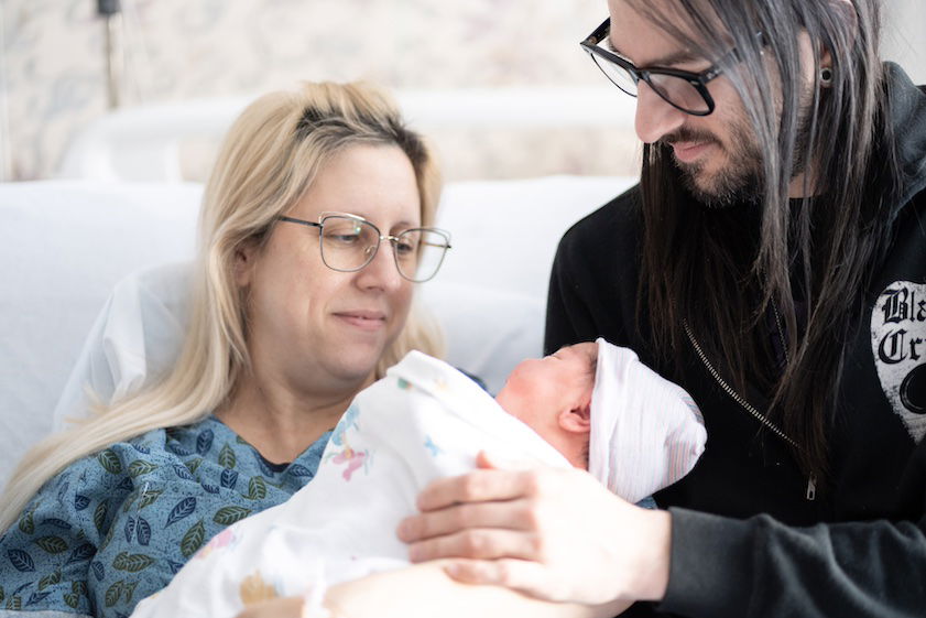 [CREDIT: Care New England] Pictured here, Warwick Leap Day Baby Sidney Lee Bilunas, shortly after arriving on-time, with parents, from left, Jessica Cullen, and Brian Bilunas.