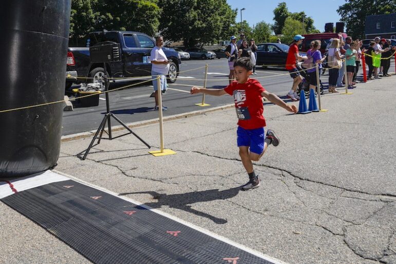 [CREDIT: Laura Paton]Eight-year-old, A. Hilario of Warwick crosses the finish line and places second in the under 12 division during the Gaspee Days 5K June 8. His time was 23:41.