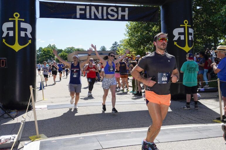 [CREDIT: Laura Paton] Steve Blanchette of Middleboro MA and Courtney Faiola of West Warwick rejoice as they cross the finish line togetherduring the June 8 Gaspee Days 5K.