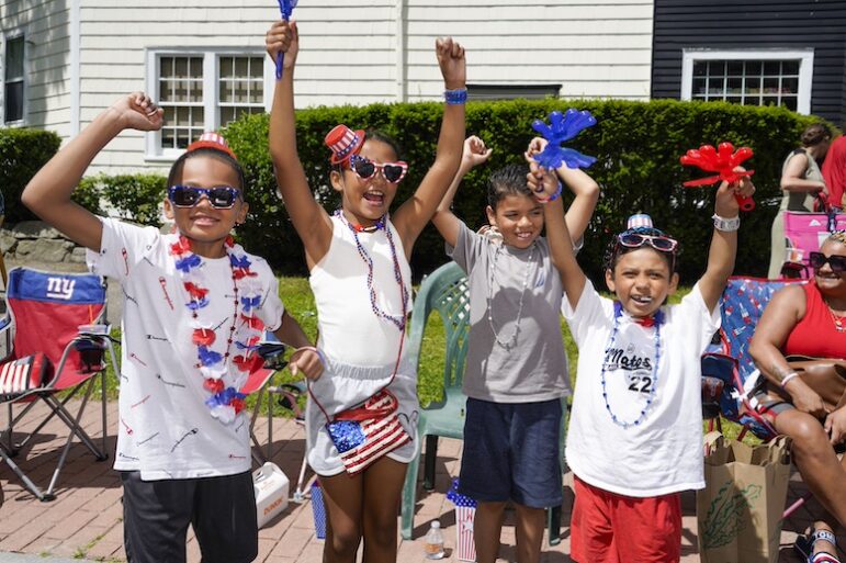 [CREDIT: Laura Paton] The Matos family cheers as the 2024 Gaspee Days Parade passes June 8.