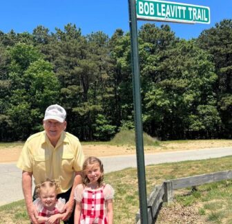 [CREDIT: Mayor Frank Picozzi] Bob Leavitt, pictured here at the sign marking Bob Leavitt Trail, which he helped build, in Warwick City Park. City flags will fly at half-staff to honor Leavitt.