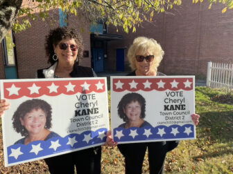 [CREDIT: Rob Borkowski] Town Council Dist. 2 candidate Cheryl Kane and a friend hold signs outside the Coventry Town Hall Annex Nov. 5.