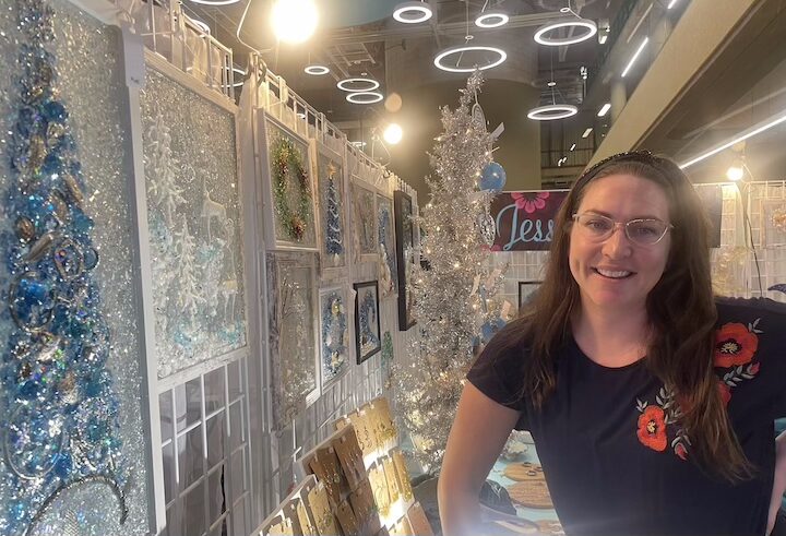 [CREDIT: Rob Borkowski] Jessie, owner of Jessie Jewels Art, with some of her Christmas Tree art for sale at the Three Ladies Craft show Friday and Saturday, Diane McConnel greeted patrons with a manual click counter and smiles. 