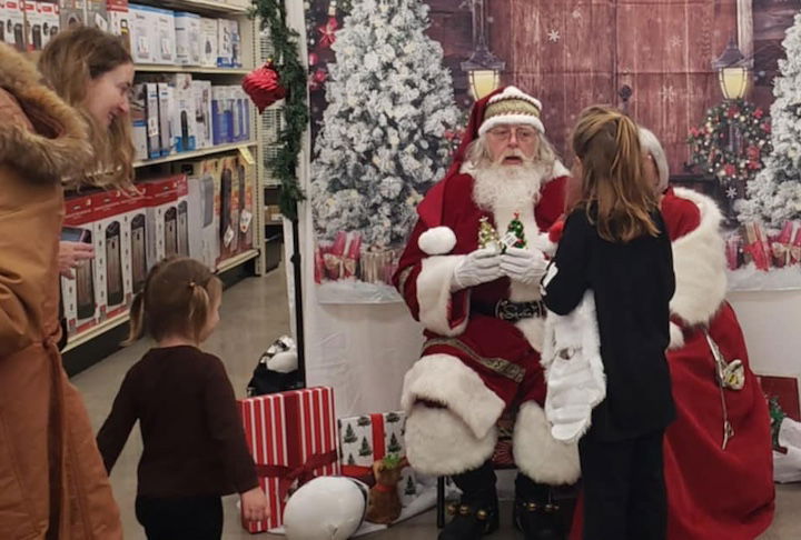 [CREDIT: Mary Carlos] From left, Lori Nold, Juliet, and Susan get photos with Mr. and Mrs. Claus during the new Warwick Ocean State Job Lot Grand Opening Nov. 23.