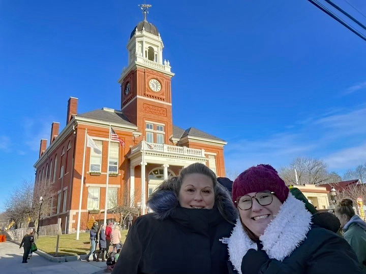 [CREDIT: Rob Borkowski] Joslyn Clemm and Jamie Thibault, tending the Greenwood Credit Union table outside the Central RI Chamber of Commerce during the Rolling, Strolling Apponaug Winter Festival Dec. 7, 2024.