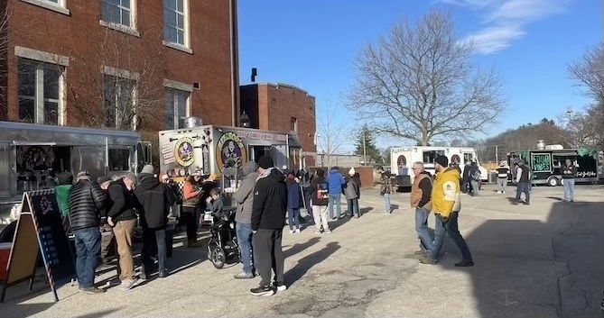 [CREDIT: Rob Borkowski] Food trucks between City Hall and Apponaug Library during the Rolling, Strolling Apponaug Winter Festival Dec. 7, 2024.