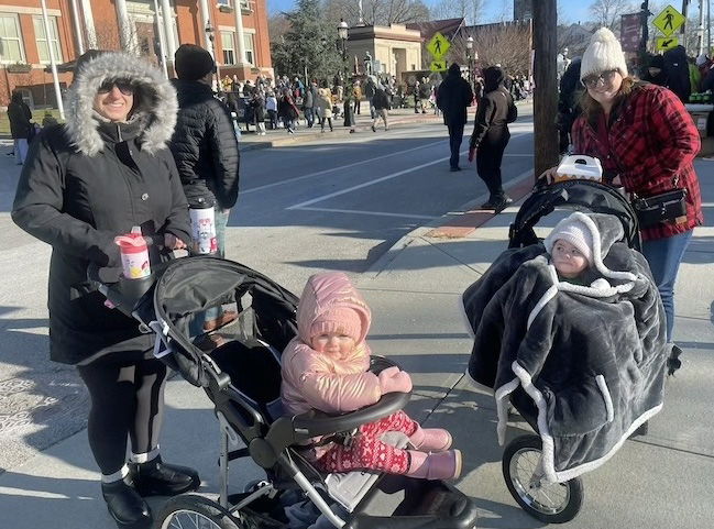 [CREDIT: Rob Borkowski] Cheryl Gobin and Olivia Guenet with respective two-year-olds, Sofia and Olivia, during the Rolling, Strolling Apponaug Winter Festival Dec. 7, 2024.