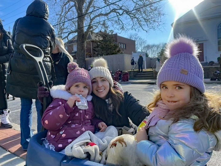 [CREDIT: Rob Borkowski] Samantha St. Pierre with Macy, 2, and Layla, 4, waiting for the parade during the Rolling, Strolling Apponaug Winter Festival Dec. 7, 2024.