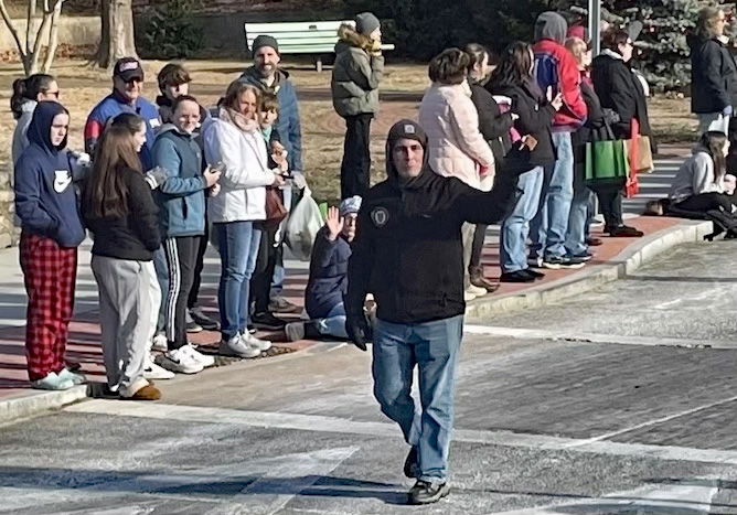 [CREDIT: Rob Borkowski] Mayor Frank Picozzi waves to the crowd in the parade during the Rolling, Strolling Apponaug Winter Festival Dec. 7, 2024.