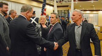  [CREDIT: Rob Borkowski] Warwick Councilman William Foley shakes hands with WFD Batallion Chief Mike Salazar as he, Councilman Jeremy Rix, Kim and Mayor Frank Picozzi chat prior to the Warwick inauguration at Crowne Plaza Jan. 7, 2025.